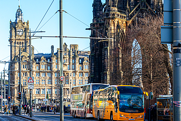 City street with buses and historic architecture under clear blue sky, Edingburgh, Scotland, United Kingdom, Europe