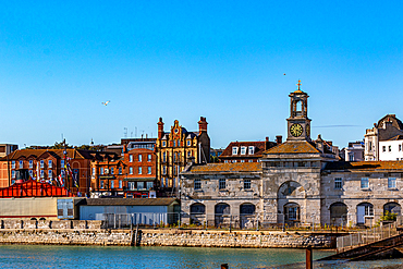 Quaint waterfront town with historic buildings under a clear blue sky, Hastings, East Sussex, England, United Kingdom, Europe