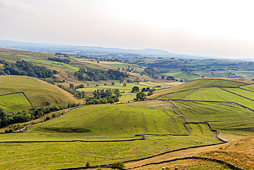 Rolling hills with patchwork fields under a hazy sky, depicting rural farmland and natural beauty, North Yorkshire, England, United Kingdom, Europe