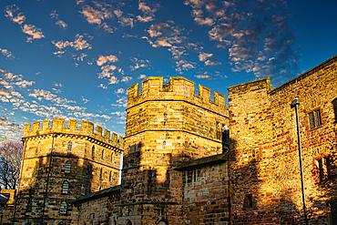 Medieval stone castle at sunset with picturesque clouds in the sky in Lancaster.