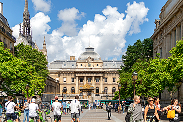 Sunny day in a bustling city square with pedestrians and classic European architecture in the background, Paris, France, Europe