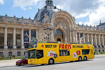 Sightseeing tour bus in front of a historic building in Paris, promoting a Best of Paris in 24 Hours tour, Paris, France, Europe