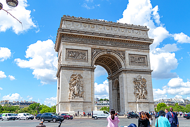 Tourists enjoying a sunny day at the iconic Arc de Triomphe, with clear blue skies in the background, Paris, France, Europe