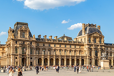 Sunny day at the Louvre Museum with tourists enjoying the architecture, Paris, France, Europe