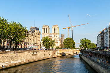 Scenic view of the Seine River with Notre-Dame Cathedral and construction crane, Paris, France, Europe