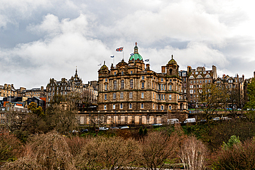 Historic building with copper domes amidst trees under a cloudy sky, Edinburgh, Scotland, United Kingdom, Europe