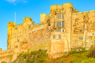 Majestic ancient castle on a hill with clear blue sky, showcasing historical architecture and heritage, Northumberland, England, United Kingdom, Europe