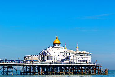 Victorian pier with a golden dome against a clear blue sky, symbolizing classic British seaside architecture, Eastbourne, East Sussex, England, United Kingdom, Europe