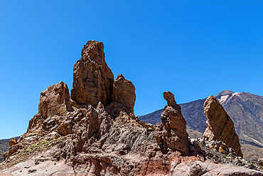 Rock formations against a clear blue sky with mountains in the background, showcasing natural erosion and geological features in the Teide National Park,UNESCO World Heritage Site, Tenerife, Canary Islands, Spain, Atlantic, Europe