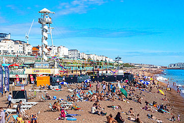 Sunny day at a crowded beach with people sunbathing and a lifeguard tower in the background, Southend-on-Sea, Essex, Englnd, United Kingdom, Europe