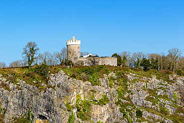 Ancient stone castle perched atop a rugged limestone hill under a clear blue sky in Bristol, England, United Kingdom, Europe