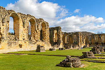 Ancient stone ruins under a blue sky with clouds, Byland Abbey, North Yorkshire, England, United Kingdom, Europe