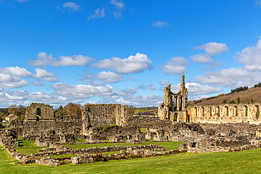 Ruins of an ancient abbey with a tower, under a clear blue sky, Byland Abbey, North Yorkshire, England, United Kingdom, Europe