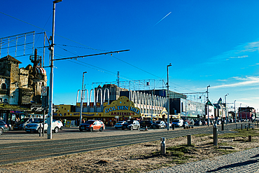 Urban street scene with cars and eclectic architecture under a clear blue sky in Blackpool, England