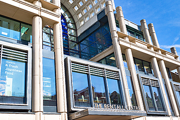 Exterior shot of The Bentall Centre building with glass windows, concrete pillars, and blue sky at Bentall Centre in Kingston, UK.