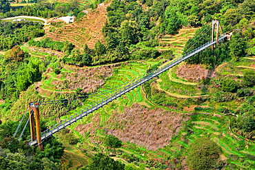 Suspension bridge over terrace farmland in Huangling, Wuyuan County, Shangrao City, Jiangxi Province, China. Huangling is an ancient village that dates back to the Ming Dynasty more than 500 years ago and is known for its natural beauty.