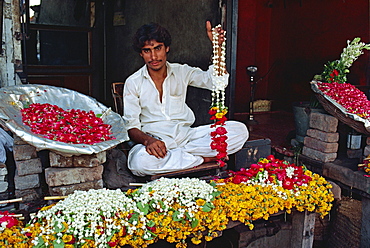 Portrait of a man selling garlands of flowers in the flower market in Lahore, Punjab, Pakistan, Asia