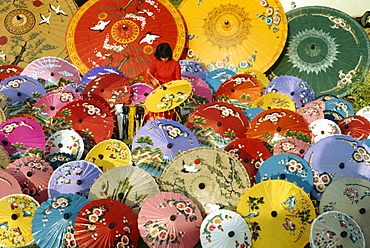 Woman painting umbrellas at Bosang in Chiang Mai, Thailand, Southeast Asia, Asia