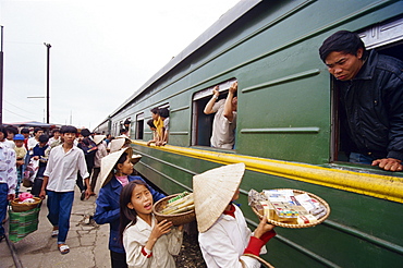 Vendors selling cigarettes and snacks to passengers on the Reunification train at Nha Trang station, set up for Saigon to Hanoi trip, Vietnam, Indochina, Southeast Asia, Asia