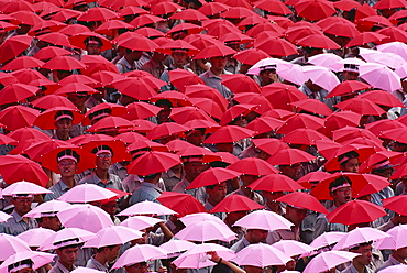 Crowds wearing red and pink umbrella hats during the annual Double Ten National Day in Taipei, Taiwan, Asia