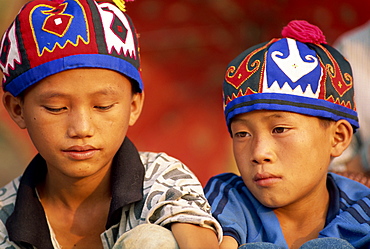 Portrait of two Hmong Hill tribe boys wearing traditional hats in Luang Prabang province, Laos, Indochina, Southeast Asia, Asia