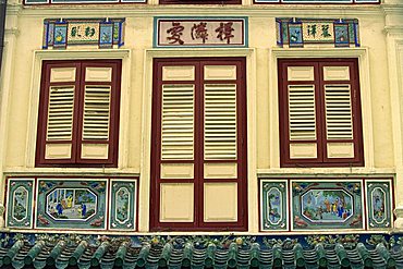 Close-up of closed shutters on doors and windows and decorative panels on the front of a house in Singapore, Southeast Asia, Asia