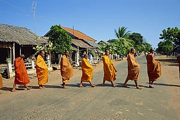 Monks with begging bowls beneath saffron robes go out in the morning in Cambodia, Indochina, Southeast Asia, Asia