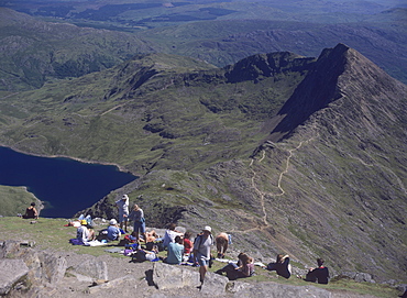 Walkers relaxing at the summit of Mount Snowdon, with Llyn Llydaw reservoir and the ridge of Y Lliwedd below, Snowdonia National Park, North Wales, Wales, United Kingdom, Europe