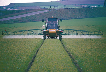 Spraying pesticides on crops in fields, Cambridgeshire, England, United Kingdom, Europe