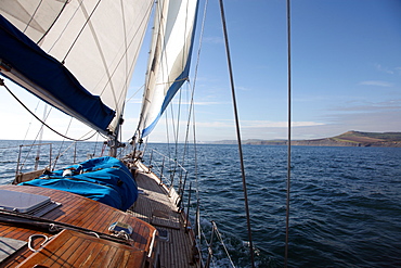 Yacht sailing west along the coast, Dorset, England, United Kingdom, Europe