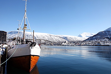 Whaler in Tromso harbour with the Bridge and Cathedral in background, Tromso, Troms, Norway, Scandinavia, Europe