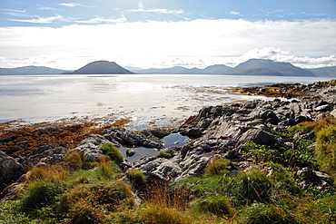 Sunlit rocks and foreshore, Helgoy, Kvalsund, Troms, North Norway, Norway, Scandinavia, Europe