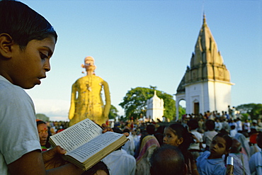 Boy follows by reading the text of the Ramlilla, the stage play of the Hindu epic the Ramayana, Varanasi, Uttar Pradesh state, India, Asia