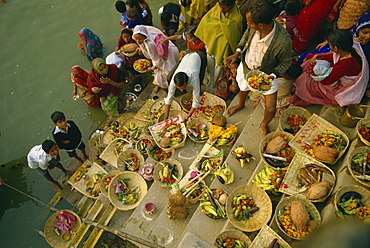 Offerings to the sun god Surya on the ghats during the Sun Worship Festival, Varanasi, Uttar Pradesh state, India, Asia