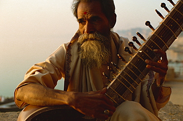 Sitar and player beside the Ganga River, Varanasi, Uttar Pradesh state, India, Asia