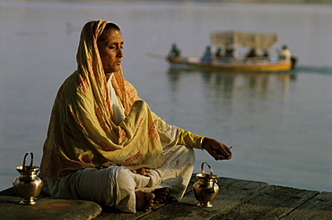 Hindu woman meditating beside the River Ganges, Varanasi (Benares), Uttar Pradesh state, India, Asia