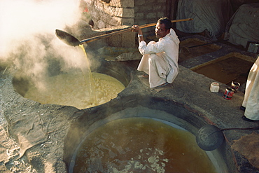 Boiling off water from cane juice to make jaggery (sugar), after sugar cane harvest, Gujarat state, India, Asia