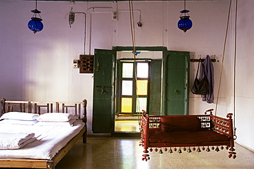 Bedroom with traditional hitchkar suspended swing seat in restored traditional Pol house, Ahmedabad, Gujarat state, India, Asia