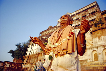 Ghatia meditating in earling morning on the ghats by the River Ganges (Ganga), Varanasi (Benares), Uttar Pradesh State, India