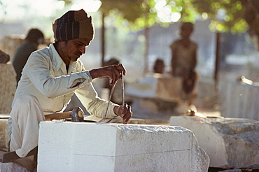 Stone mason carving marble for the renovation of upkeep of Jain temples, Kumbariajyi, source of Rajasthan's marble quarried out of the Aravalli Hills, Rajasthan state, India, Asia