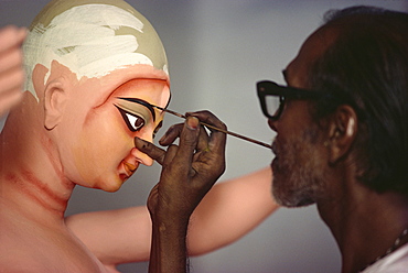 Painting clay based image of Durga, the ten armed warrior goddess, for use in the Durga Puja festival, Varanasi, Uttar Pradesh, India, Asia