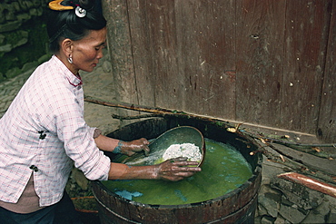 Lime being added to indigo paste, Guizhou, China, Asia