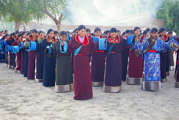 Tibetan women pray at Harvest Festival, Tongren Area, Qinghai Province, China