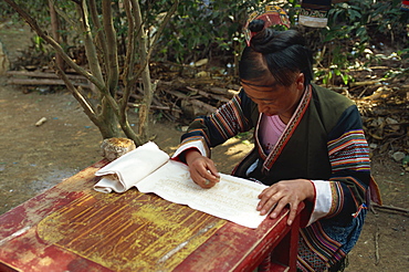 Miao girl doing wax resist, southern Guizhou, Guizhou, China, Asia