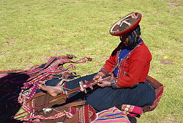 Portrait of a Quechua Indian woman weaving on a narrow loom at the open air Sunday market at Chincheros, Peru, South America