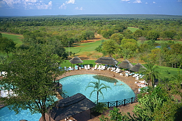 Aerial view over Elephant Hills Hotel swimming pool and golf course, near Victoria Falls, Zimbabwe, Africa