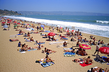 Tourists and locals at popular hot-spot on Renaca Beach, Vina del Mar, Chile, South America