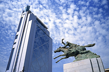 Modern skyscraper and statue show contrast of the old and the new, Santiago, Chile, South America