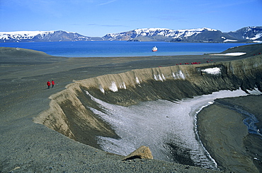 Tourists on rim of volcano, active in 1970, one of two in Antarctica, with cruise ship in the background, on Deception Island, Antarctic Peninsula, Antarctica, Polar Regions