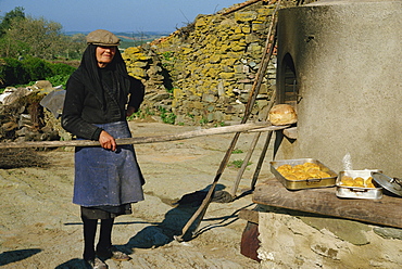 Woman baking bread, Alentejo, Portugal, Europe